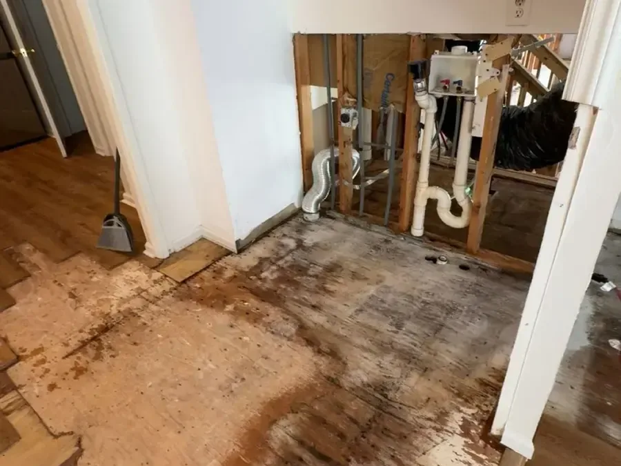 Opened wall around the supply plumbing with the wet flooring pulled up