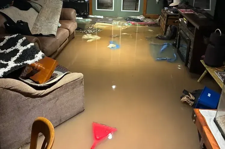 Floodwater standing in a living room after a heavy storm