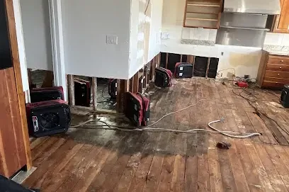 Buckled floor boards soaked by water from a burst pipe